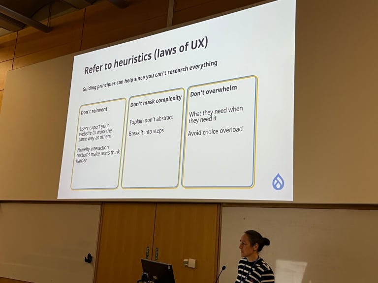 Photo of Emma Horrell speaking about using heuristics from UX concepts to help users.